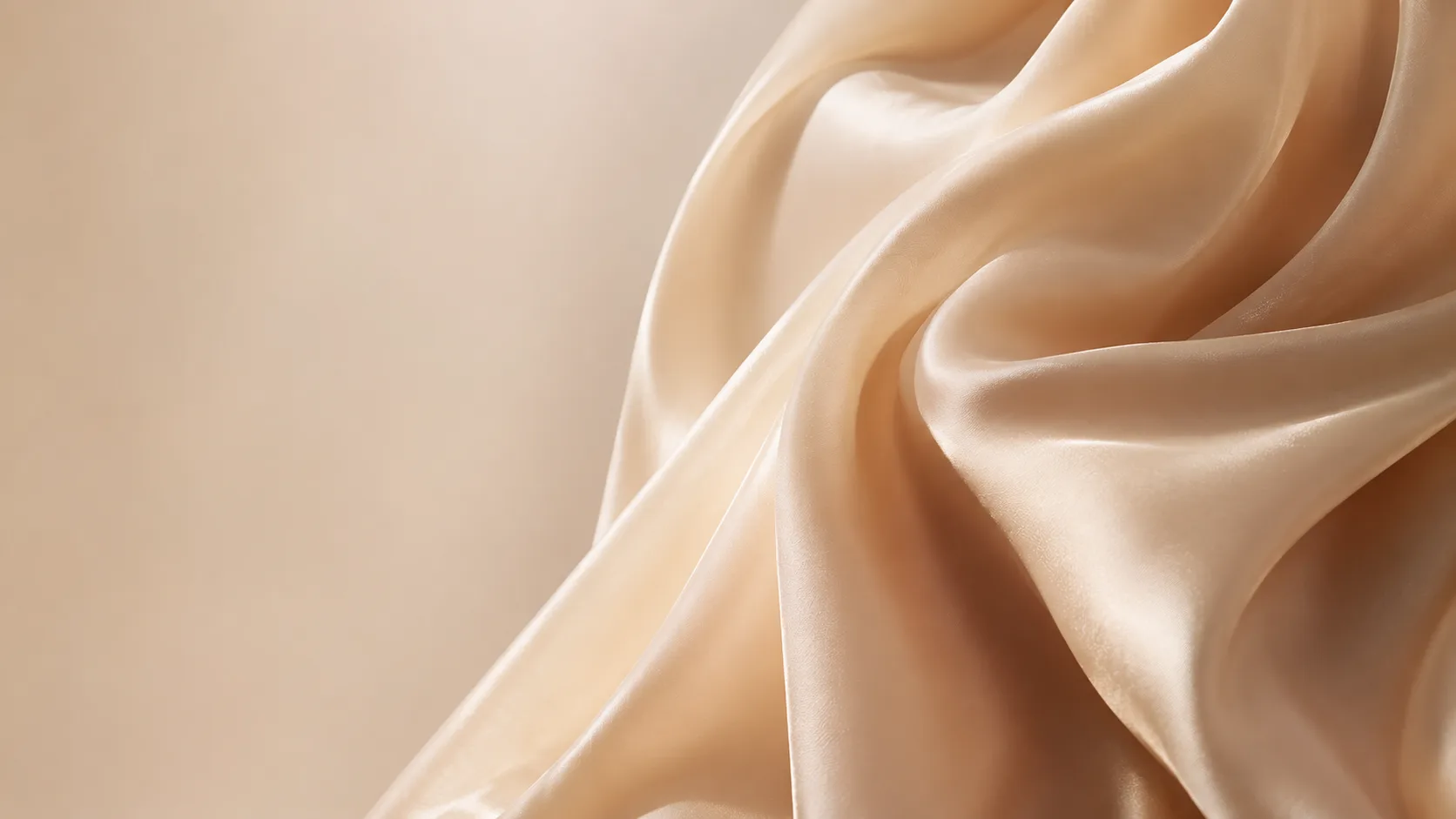 Champagne silk fabric draped over unseen form, macro detail