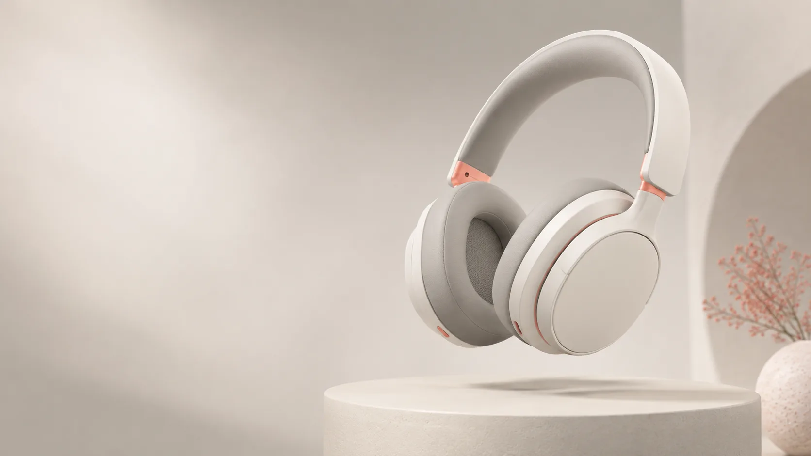 Pair of unbranded over-ear headphones floating above a soft podium