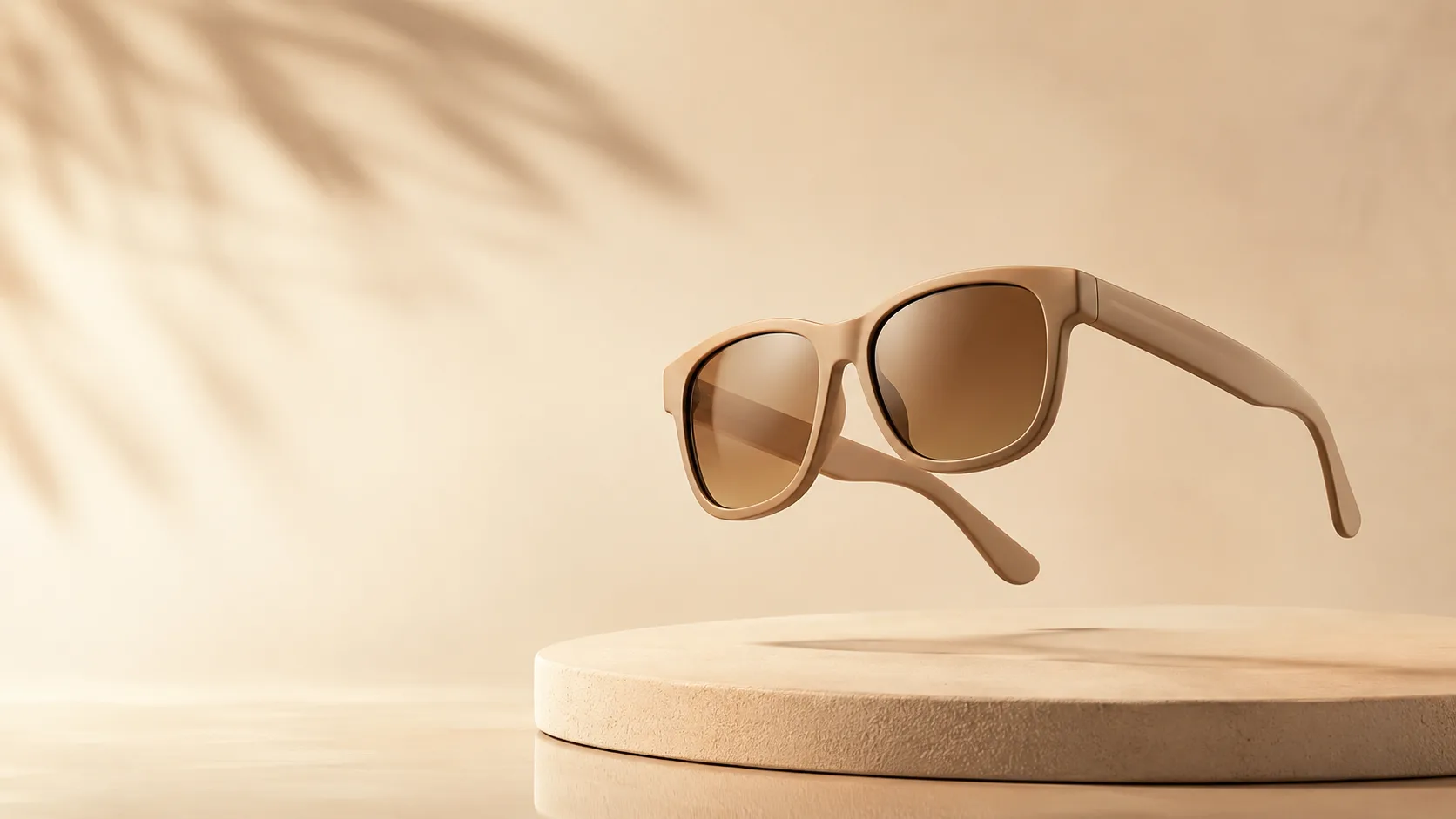 Pair of modern sunglasses floating at an angle above a soft podium in sand tones