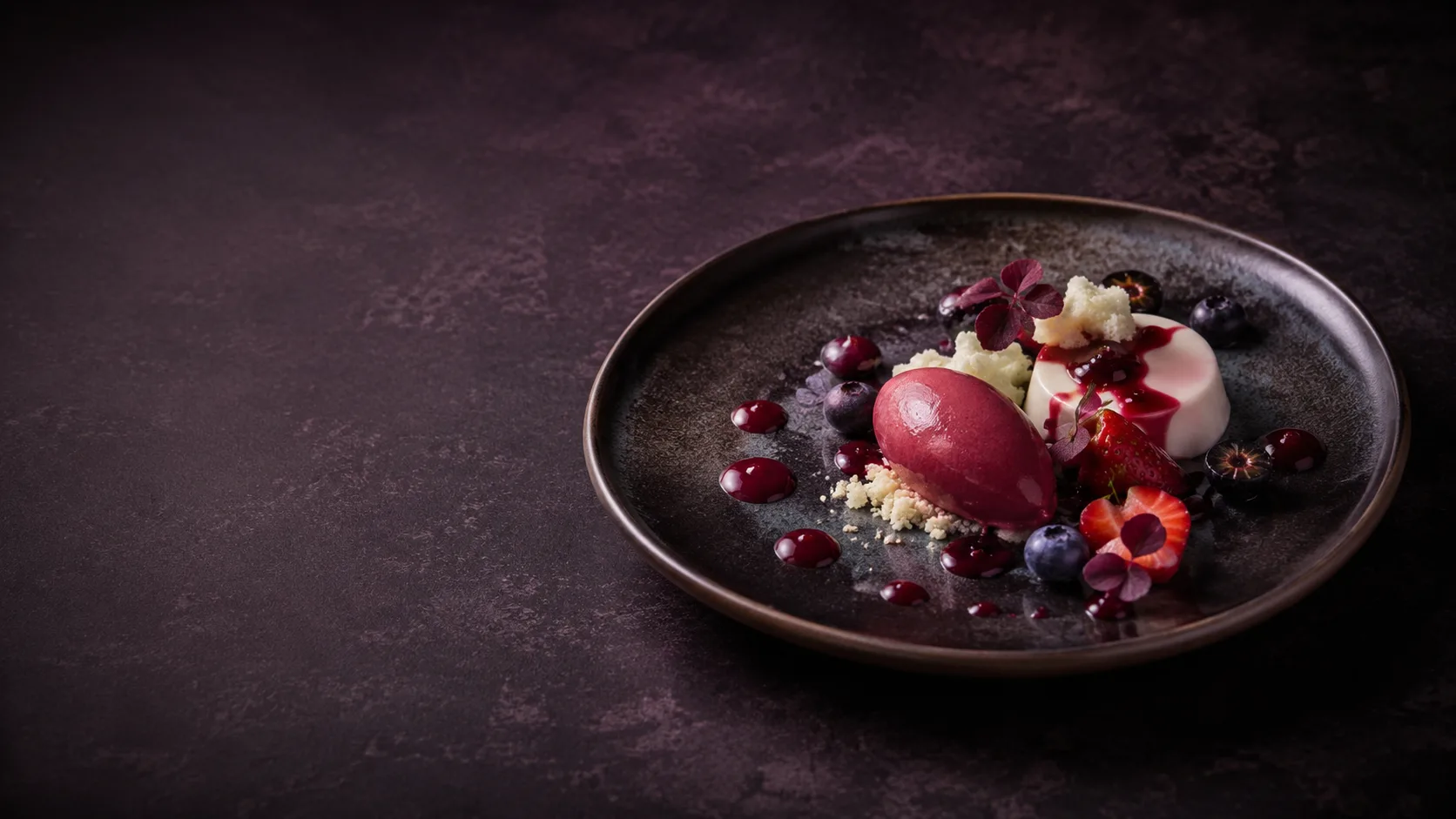 Editorial photograph of a fine-dining plated dessert with a quenelle and berries