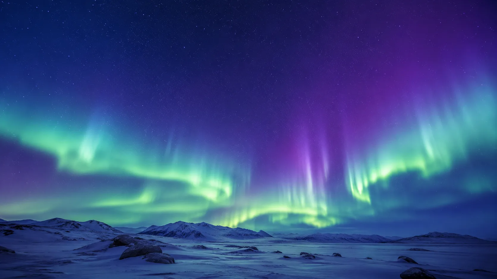 Aurora boreal verde ondulando sobre un cielo nocturno y una cordillera en silueta