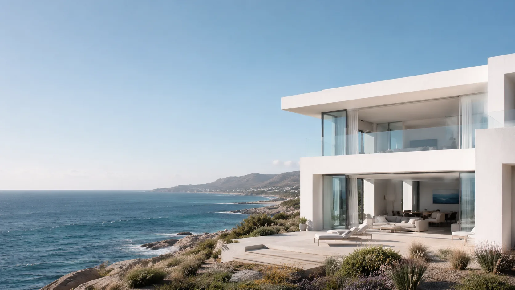 Editorial architecture photograph of a coastal modern house with white volumes over the sea