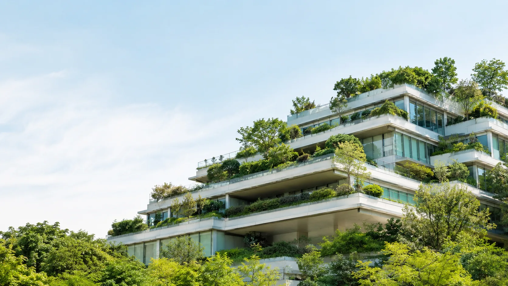 Editorial architecture photograph of a modern building with cascading rooftop garden terraces
