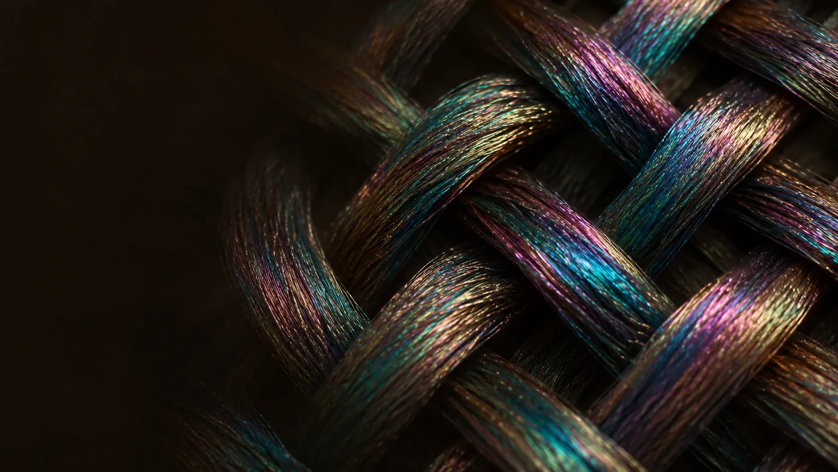 Macro of woven iridescent threads with oil-slick shimmer on dark warm