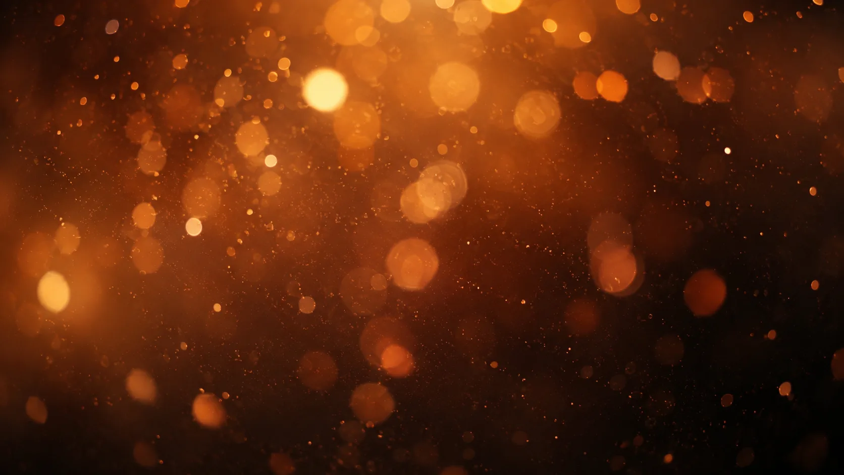 Fondo de bokeh con círculos de luz ámbar desenfocados sobre un degradado oscuro