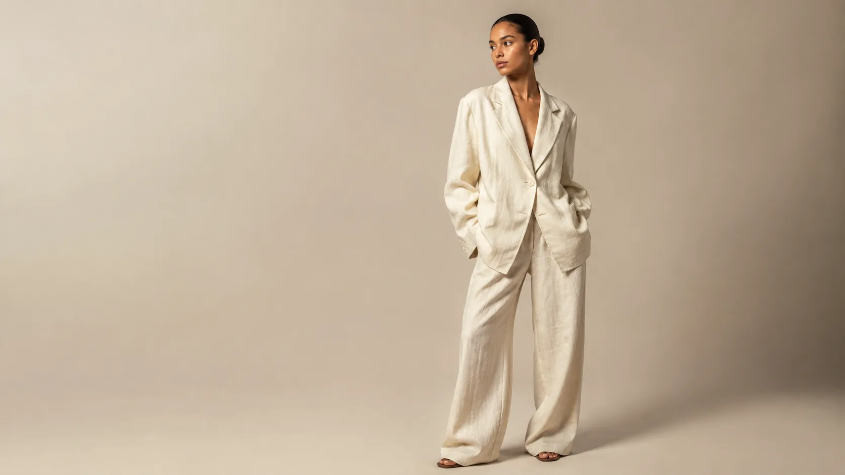 Editorial portrait of model in minimalist cream linen oversized suit